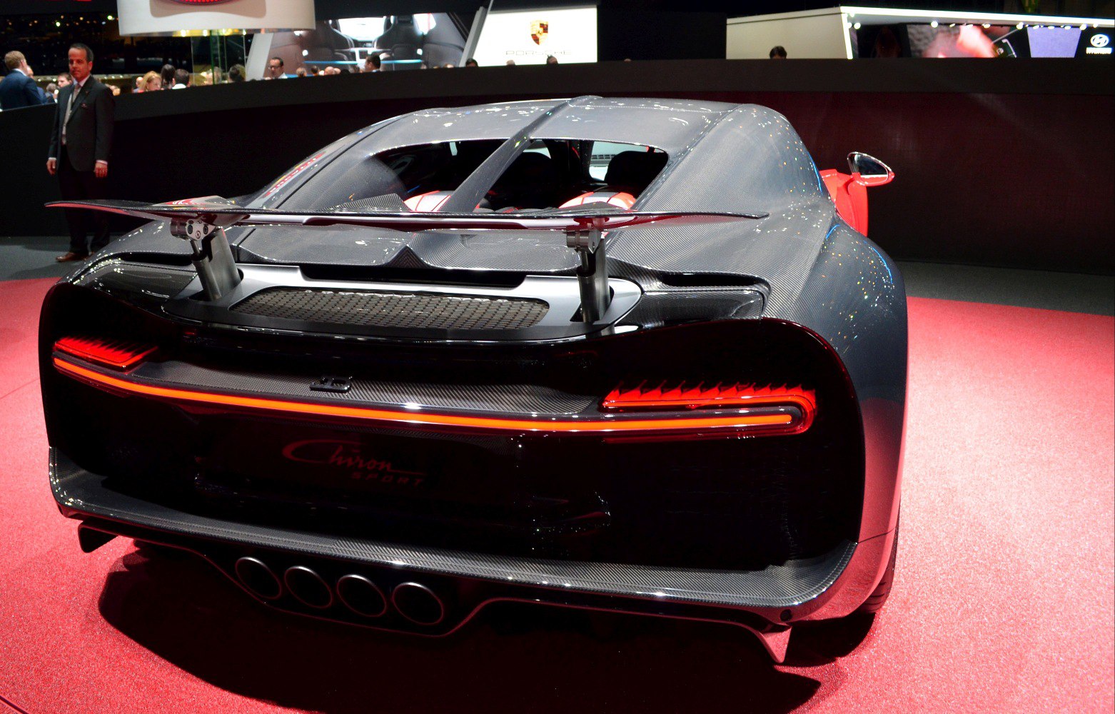 Rear view with spoiler, continuous LED taillights, and quad exhaust pipes