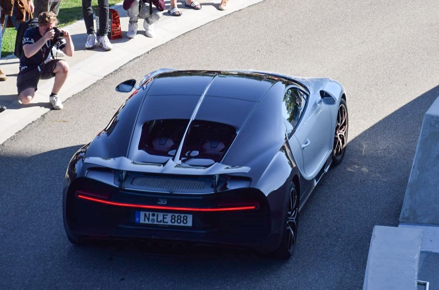 Rear view with continuous LED light strip and visible engine cover