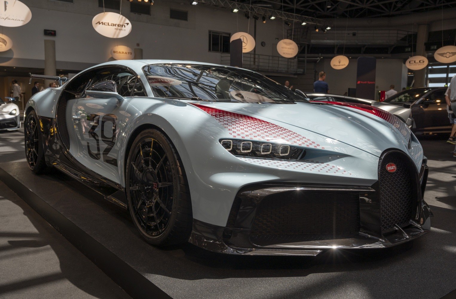 Front and side view of a luxury sports car with distinctive headlights and aerodynamic features