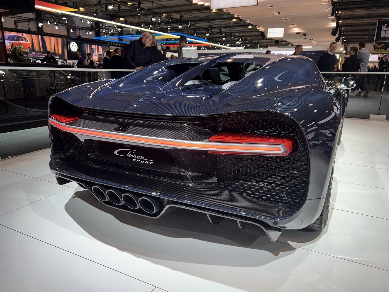 Rear view with quad exhaust pipes and slim tail light strip.