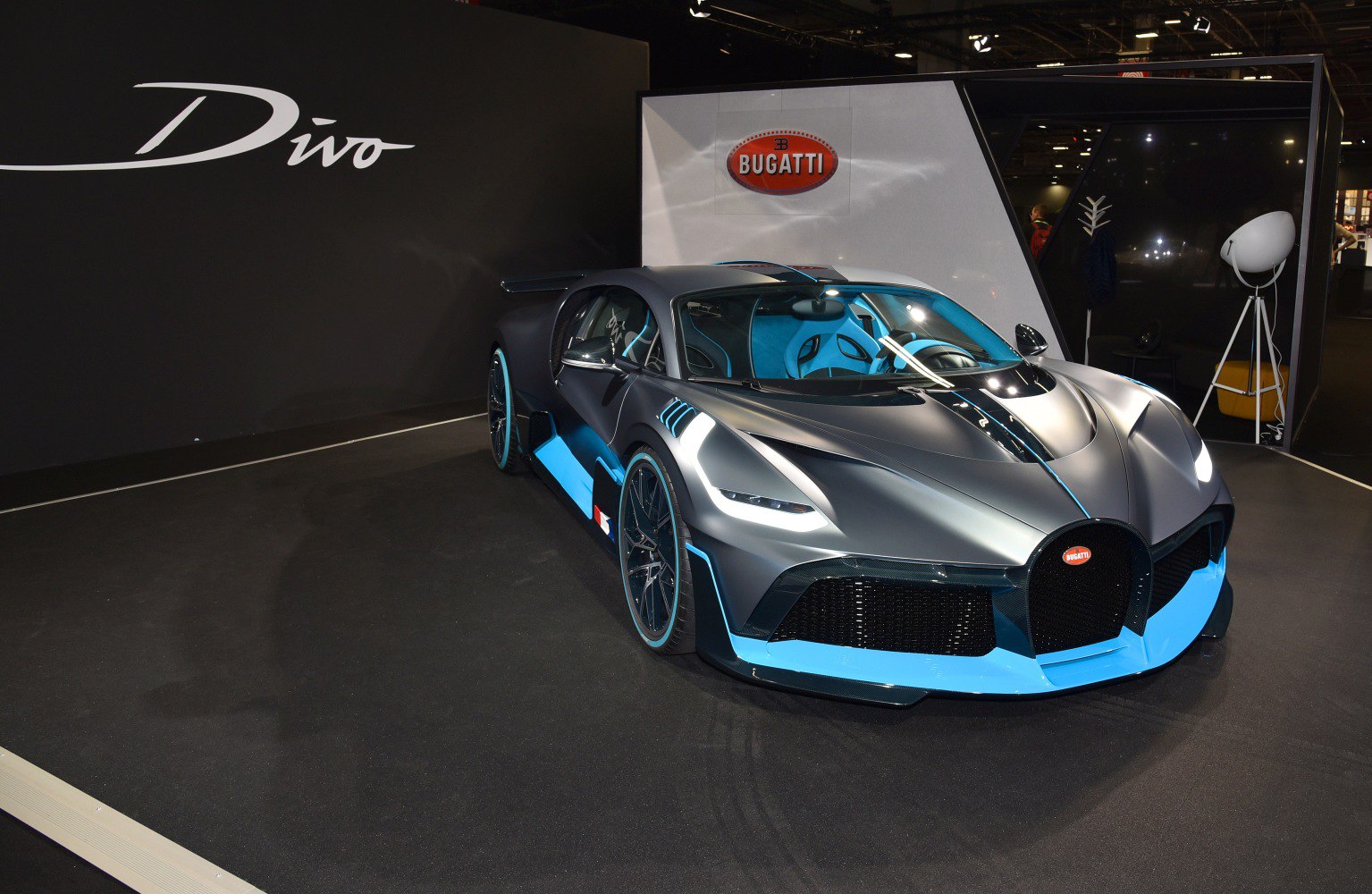 Front angled view of a sports car with aerodynamic design and blue detailing