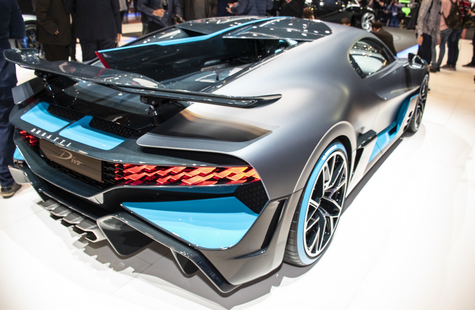 Rear and side view with aerodynamic wing and diffuser, blue and black body livery.