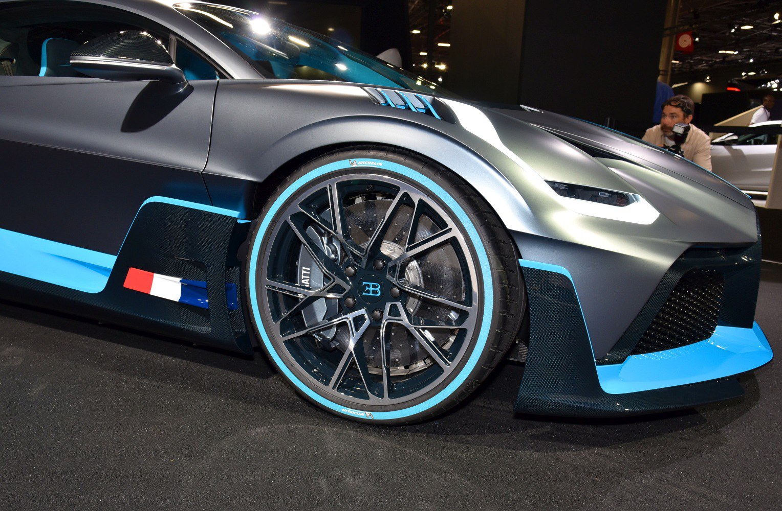 Front wheel with blue accent rims and aerodynamic design elements