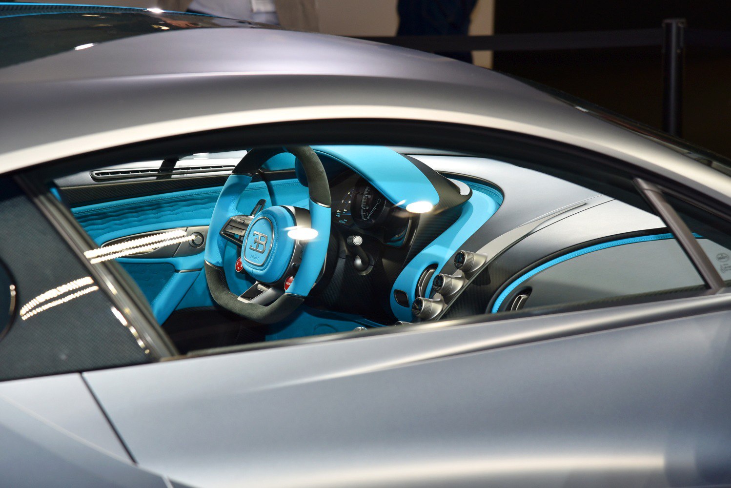 Blue car interior with modern steering wheel and cluster