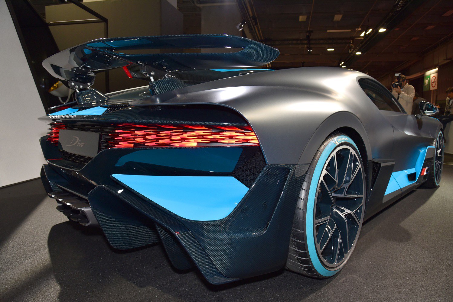 Aerodynamic carbon wing and unique LED taillights on hypercar rear.