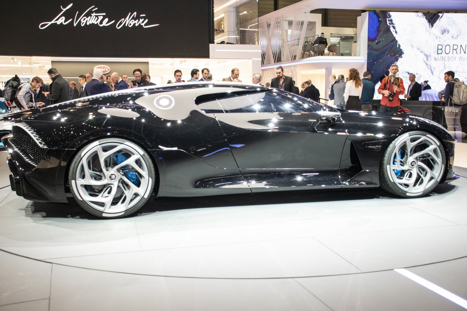 Sleek black supercar side profile with futuristic rims