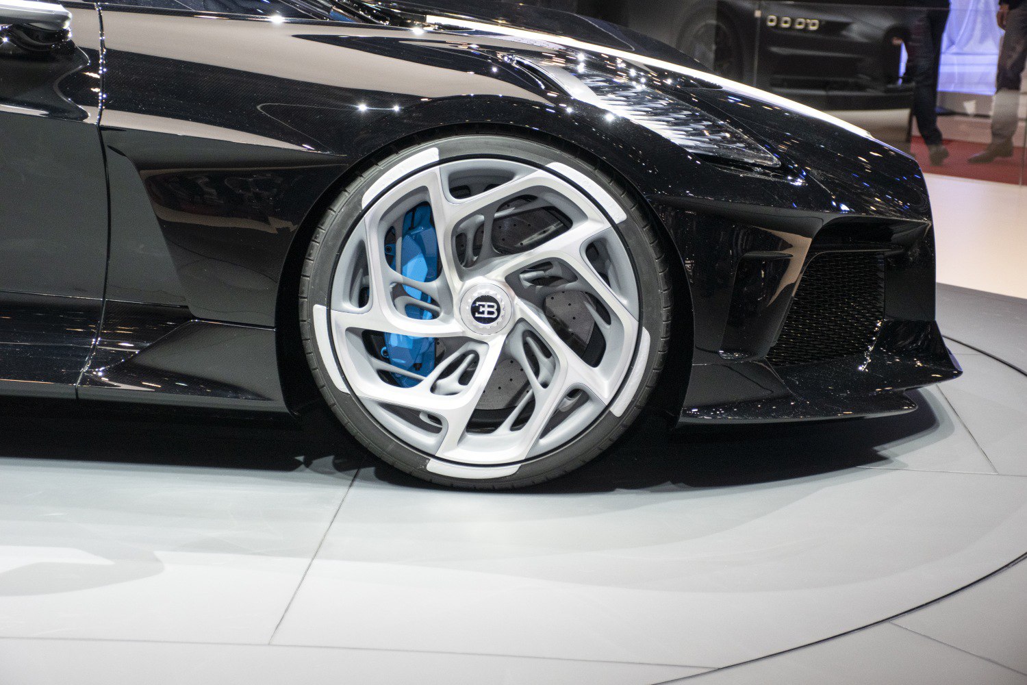 Front wheel with unique alloy rim and blue brake caliper.