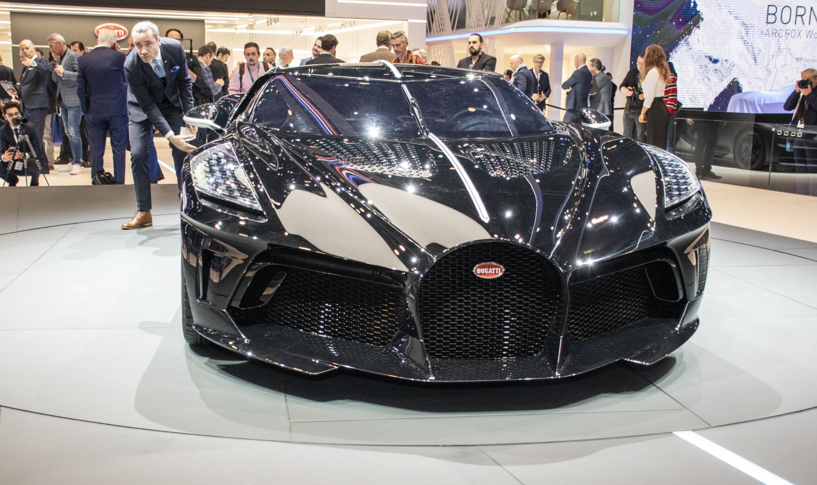 Sleek black supercar front with aerodynamic vents and distinctive headlights