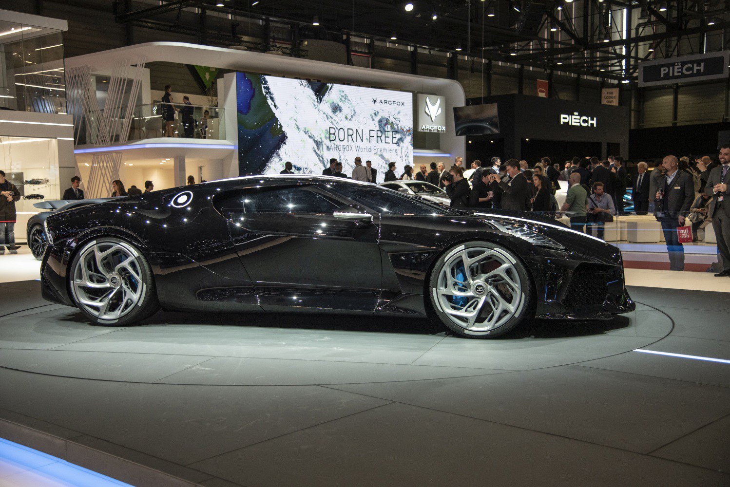Sleek black luxury hypercar with aerodynamic body and distinctive alloy wheels