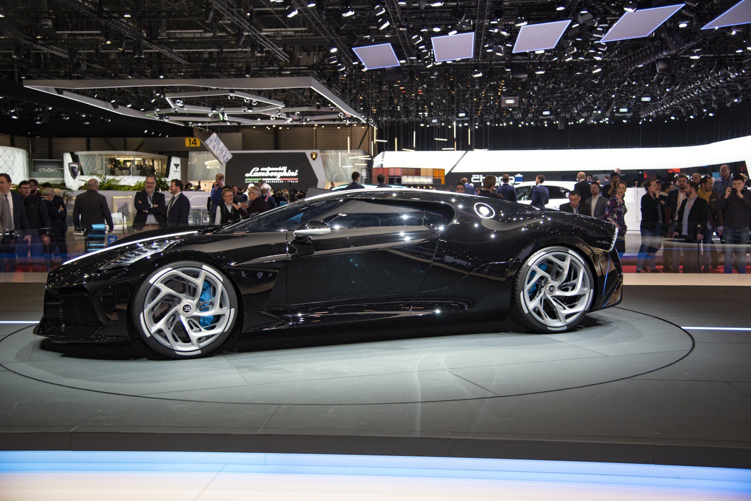 Glossy black luxury sports car with aerodynamic design and distinctive alloy wheels