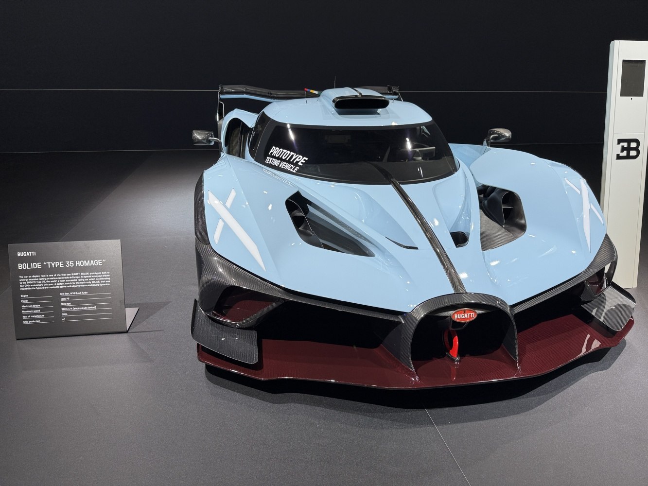 Front view of a prototype hypercar with aerodynamic design and carbon fiber elements.