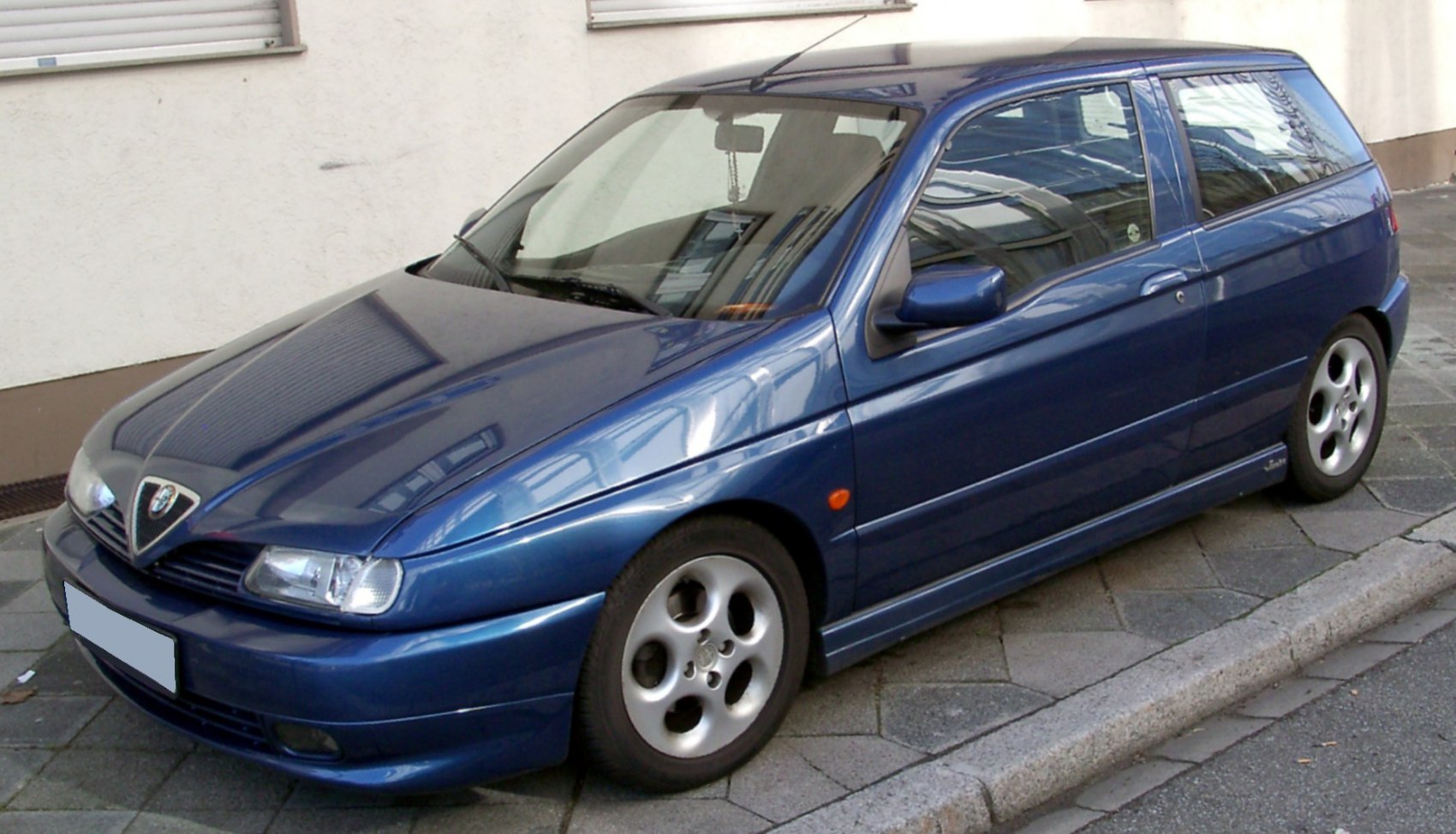 Blue compact hatchback with angular headlights and alloy wheels