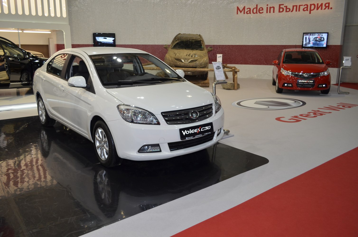 White sedan front view with grille and headlights on display