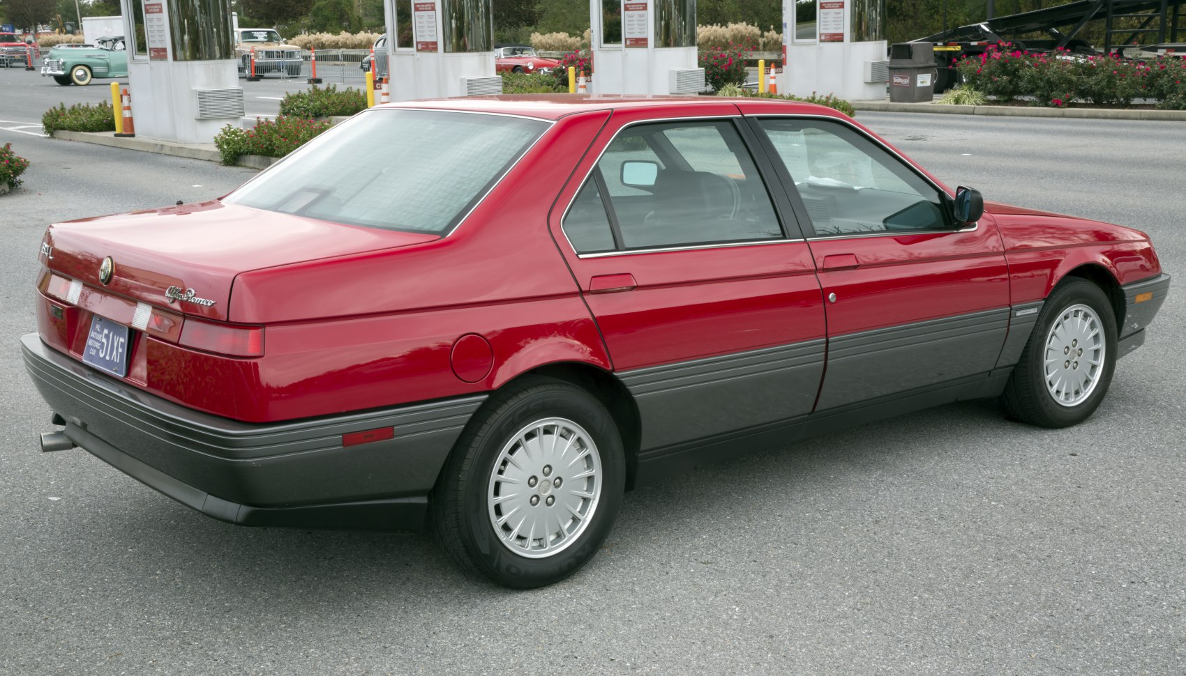 Rear and side profile of a two-tone painted classic sedan.