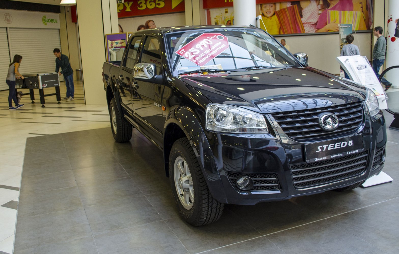 Pickup truck front and side view with grille, headlights, tires.