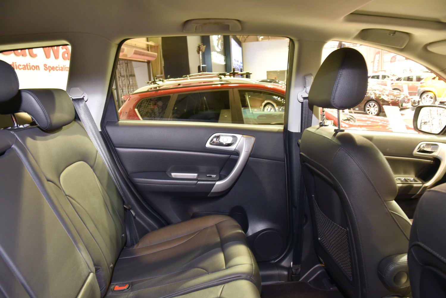 Leather rear seats and door panel interior with seatbelt and headrest details.