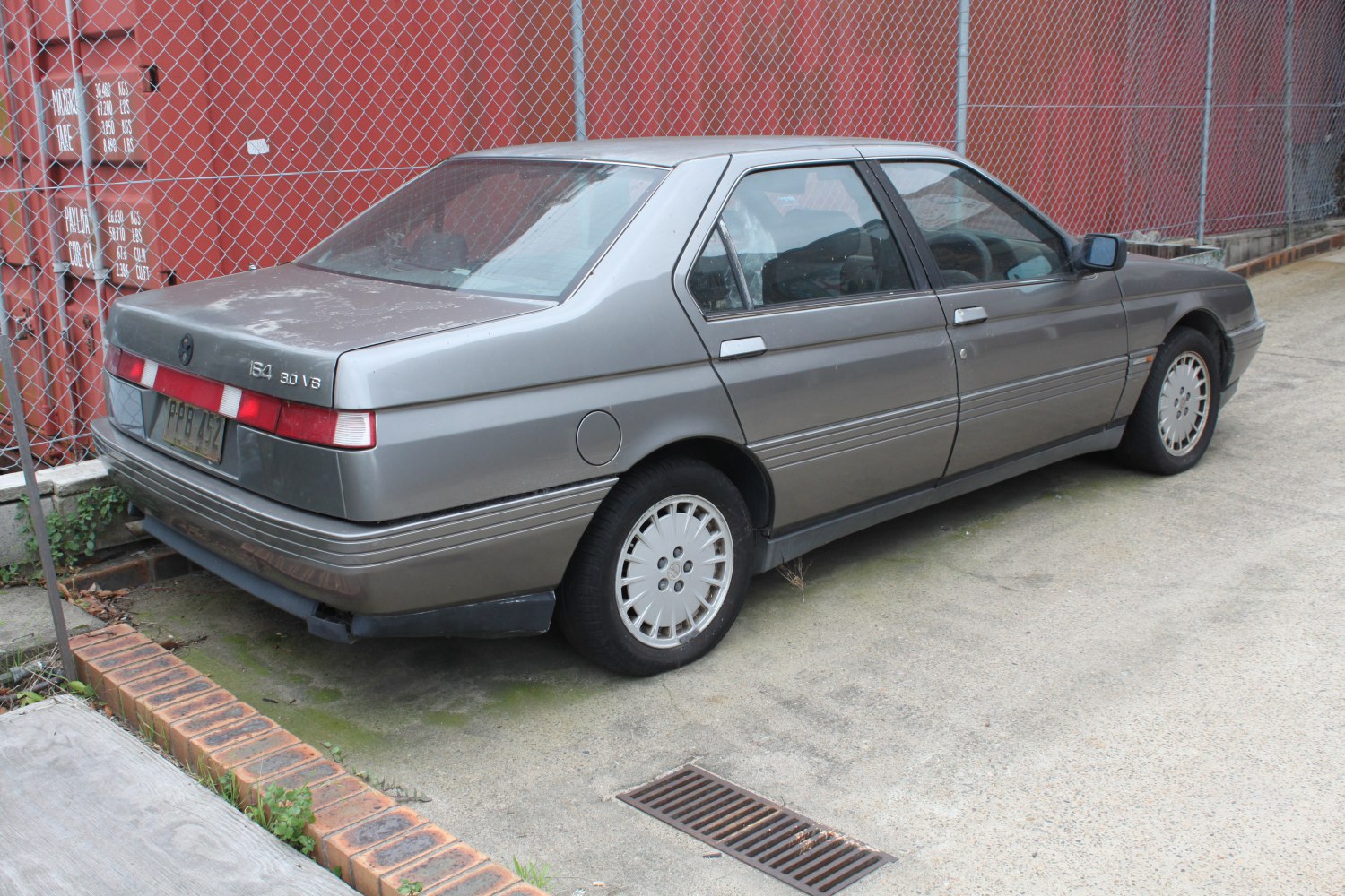 Rear side view of a 1980s four-door sedan with alloy wheels