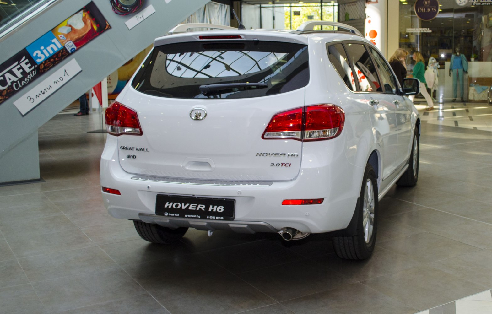 Rear view of white 4WD SUV with taillights and exhaust pipe