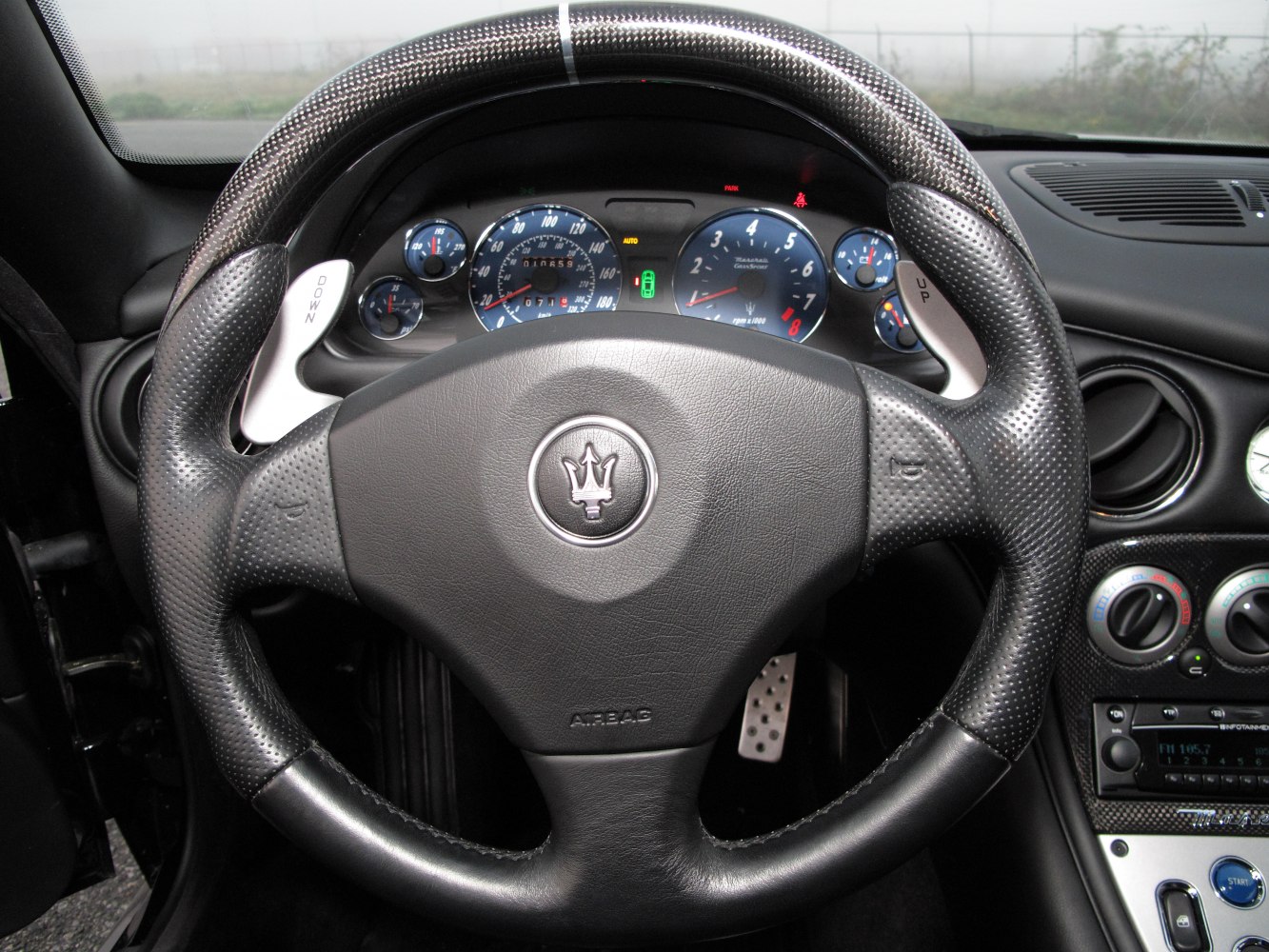 Leather steering wheel with paddle shifters and blue instrument cluster