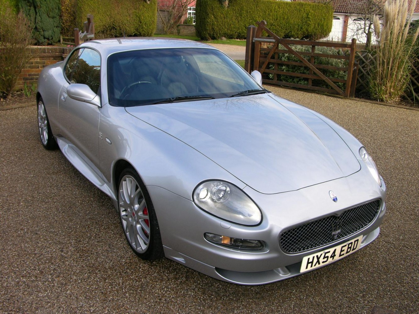 Silver luxury sports coupe with prominent front grille and aerodynamic design.