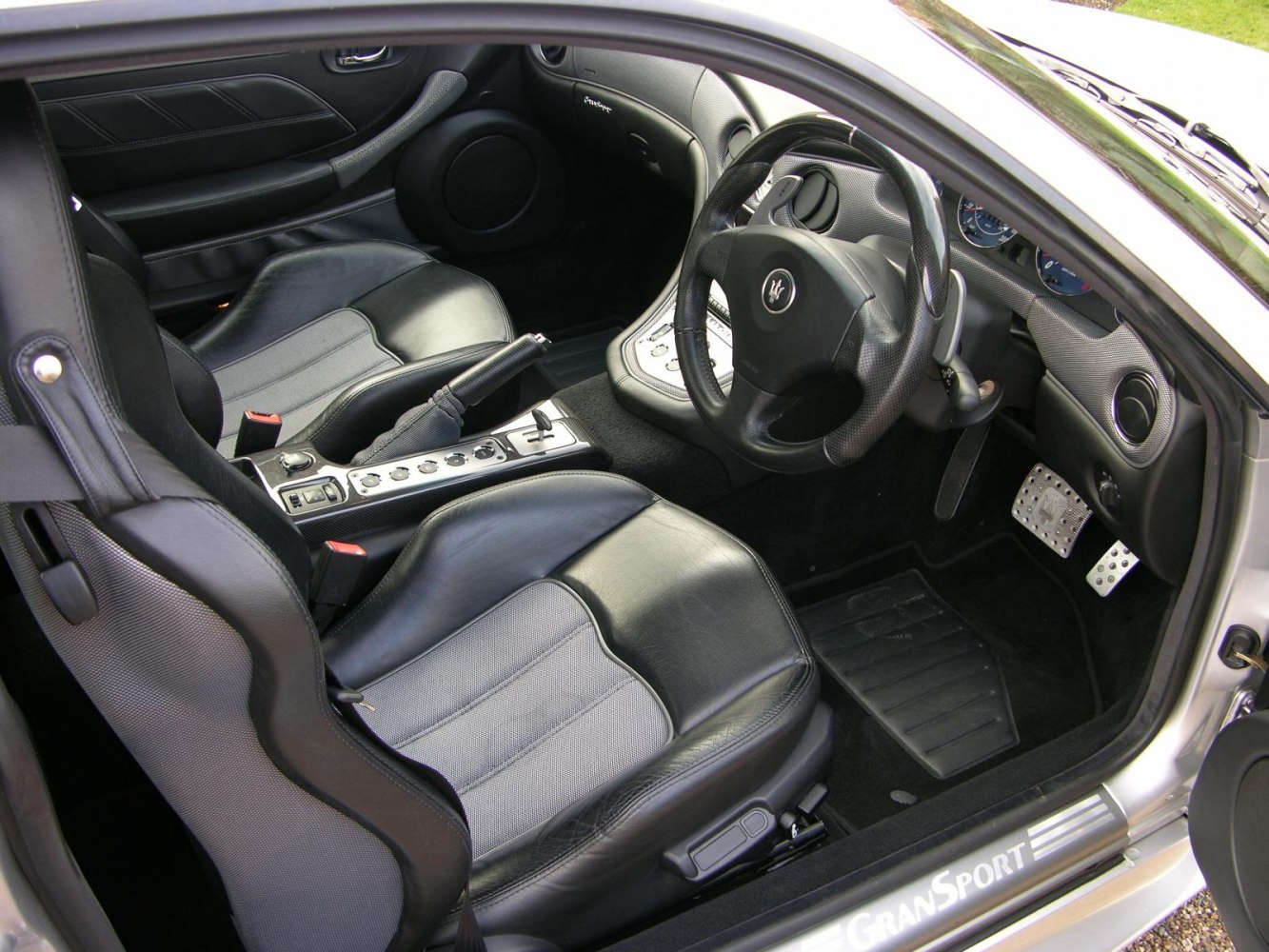Black leather sport seats and detailed driver cockpit with steering wheel