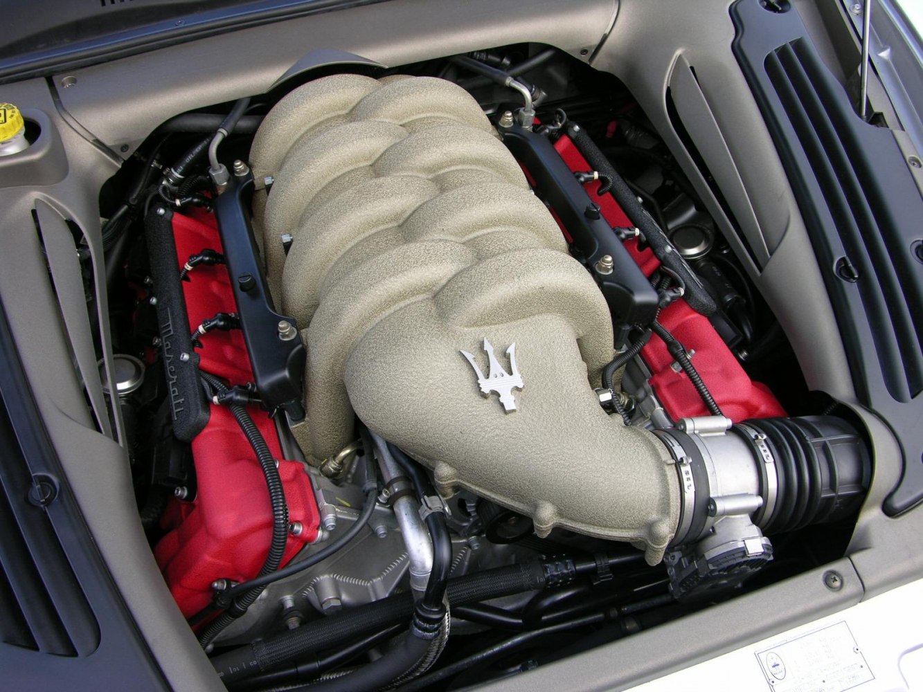 Detailed V8 engine intake manifold with red valve covers