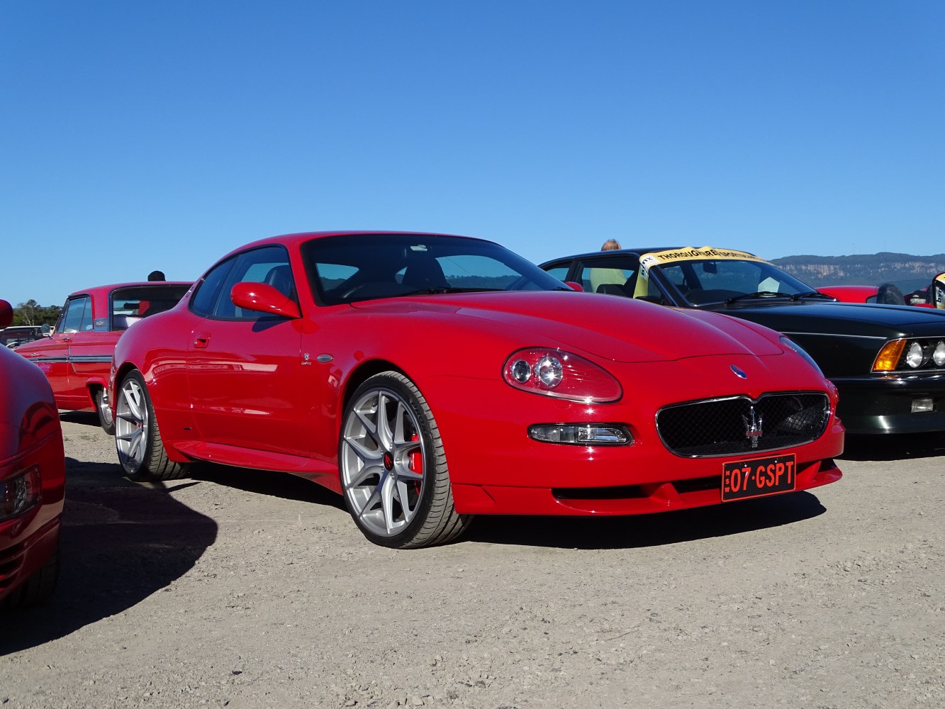 Front side red sports coupe with alloy wheels