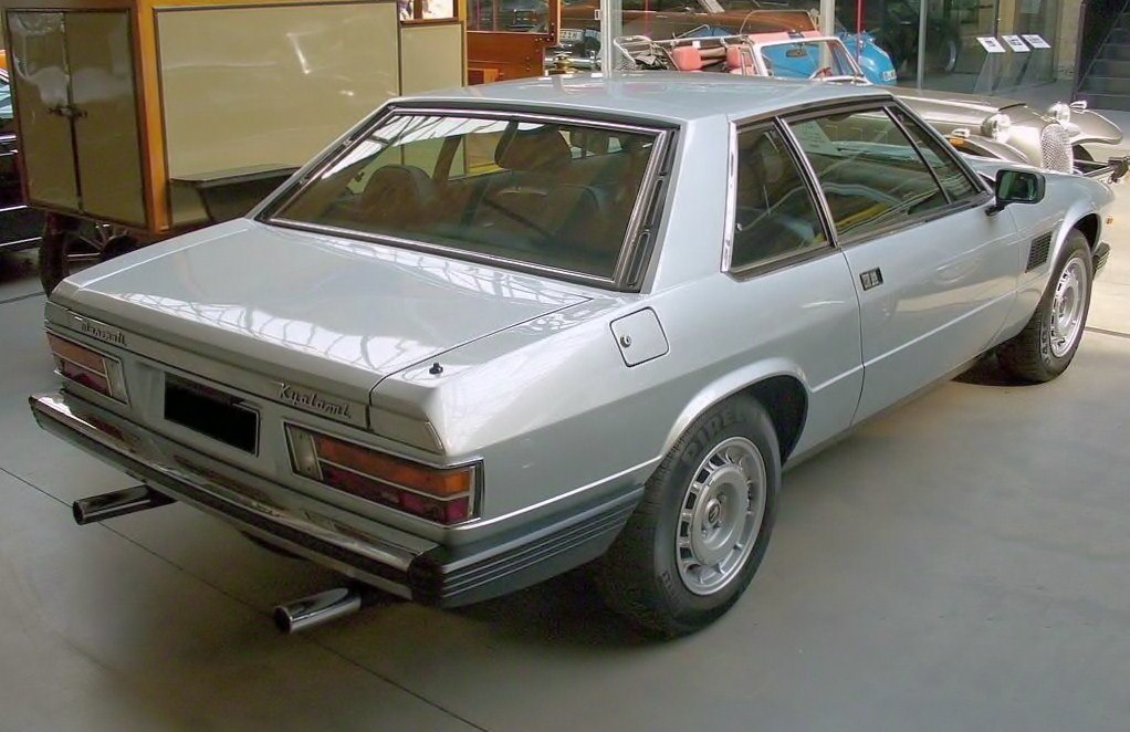 Rear view of a classic angular coupe with chrome bumper and distinct taillights.