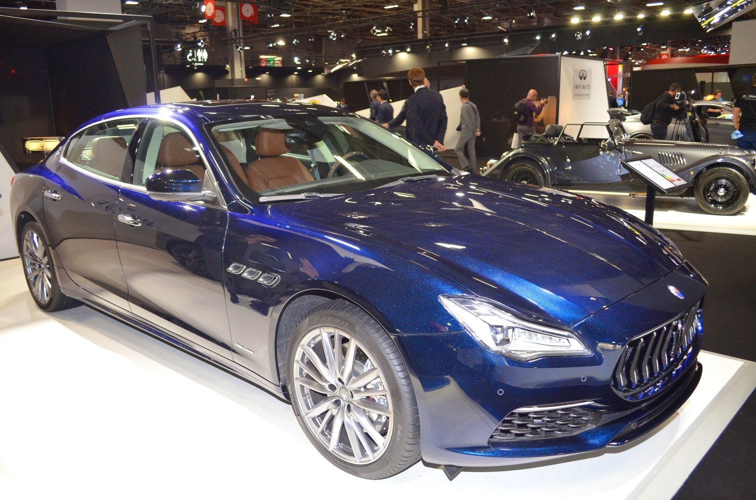 Blue luxury sedan with vertical slat grille and LED headlights