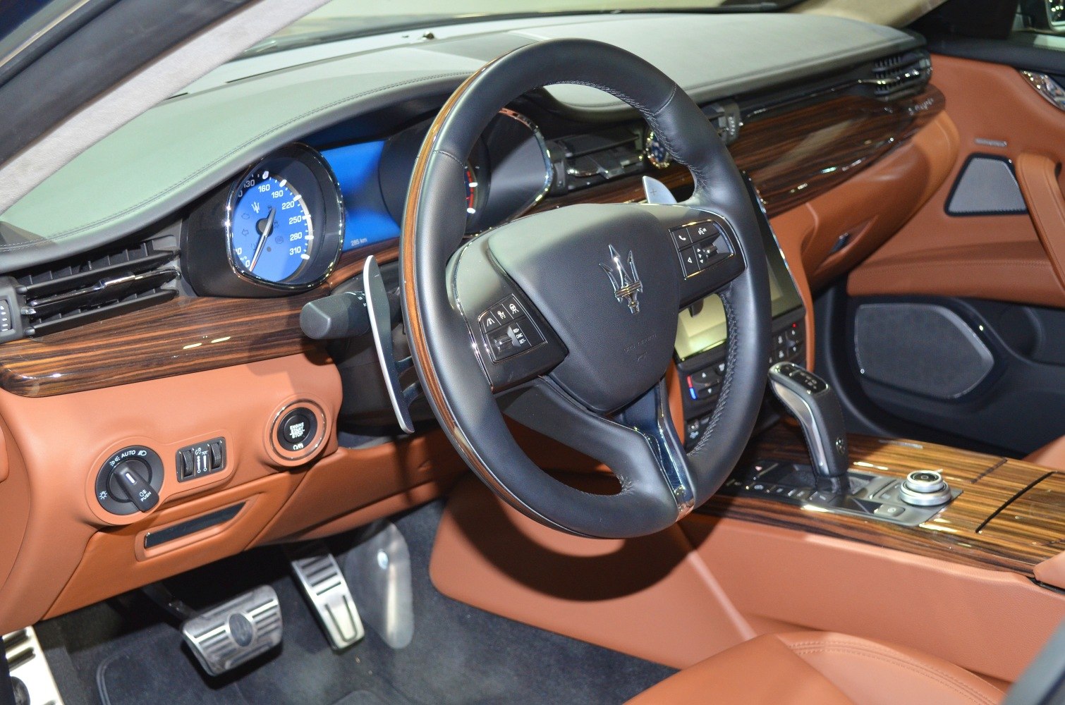 Luxury car interior with wood trim and digital instrument cluster