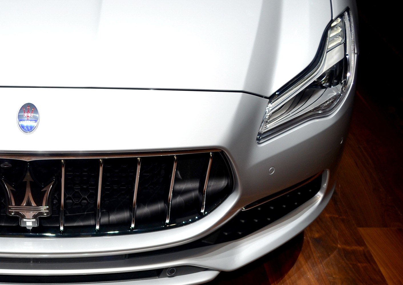 Close-up of front grille and headlight of a luxury sedan