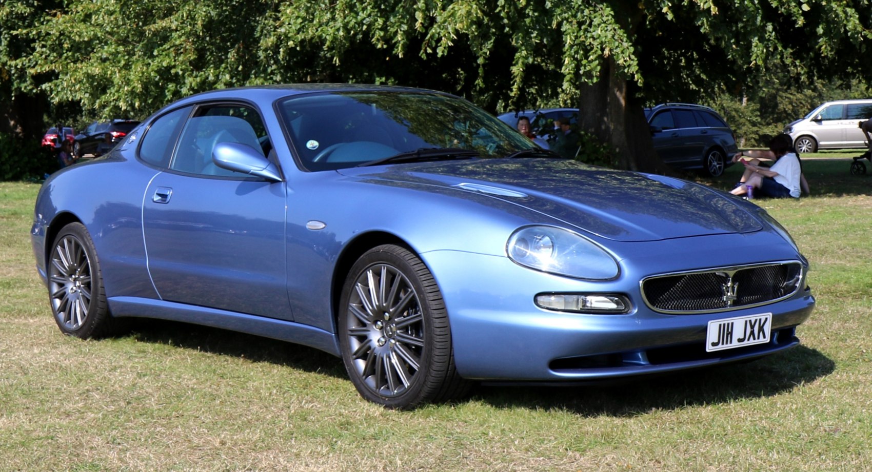 Blue luxury coupe with sleek aerodynamic design and alloy wheels.