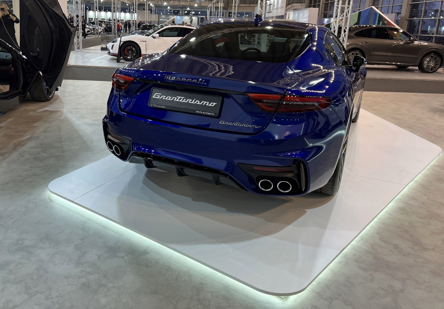 Sleek rear with quad exhaust pipes and distinct tail lights