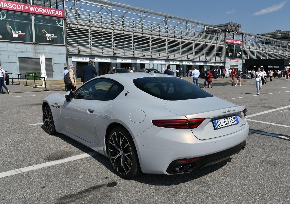 Rear side view of white coupe with quad exhaust and distinctive alloy wheels