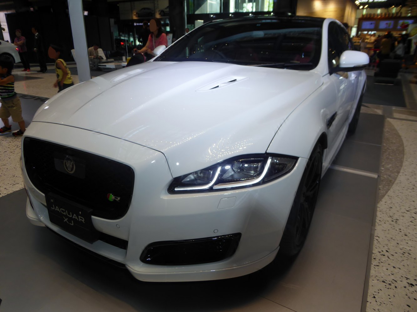 Front view of luxury sedan with LED headlights and distinctive hood vents