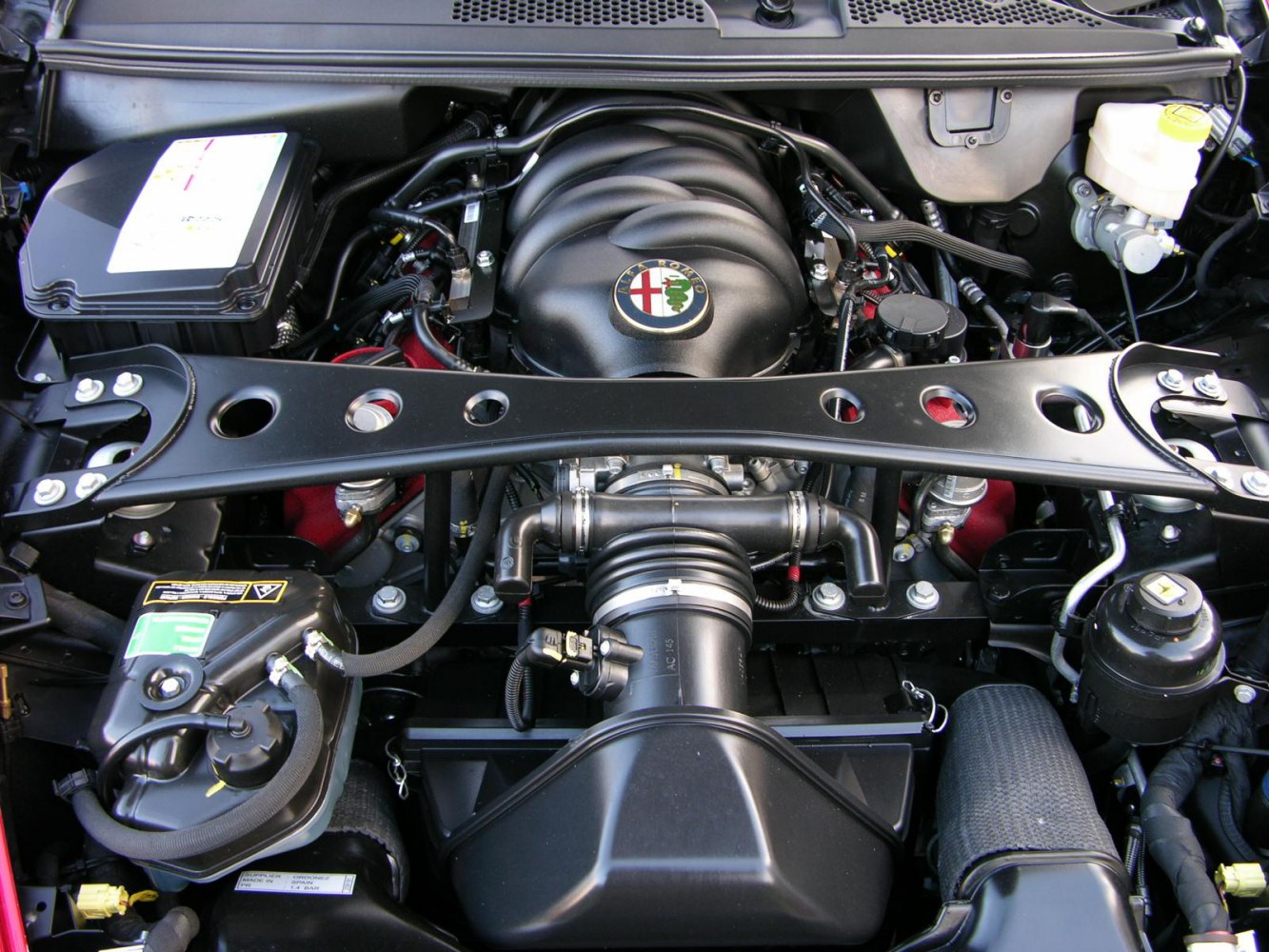 High-performance engine bay with strut brace and air intake assembly