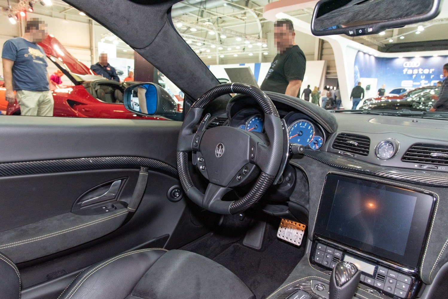 Luxury sports car interior with carbon fiber trim and digital dashboard