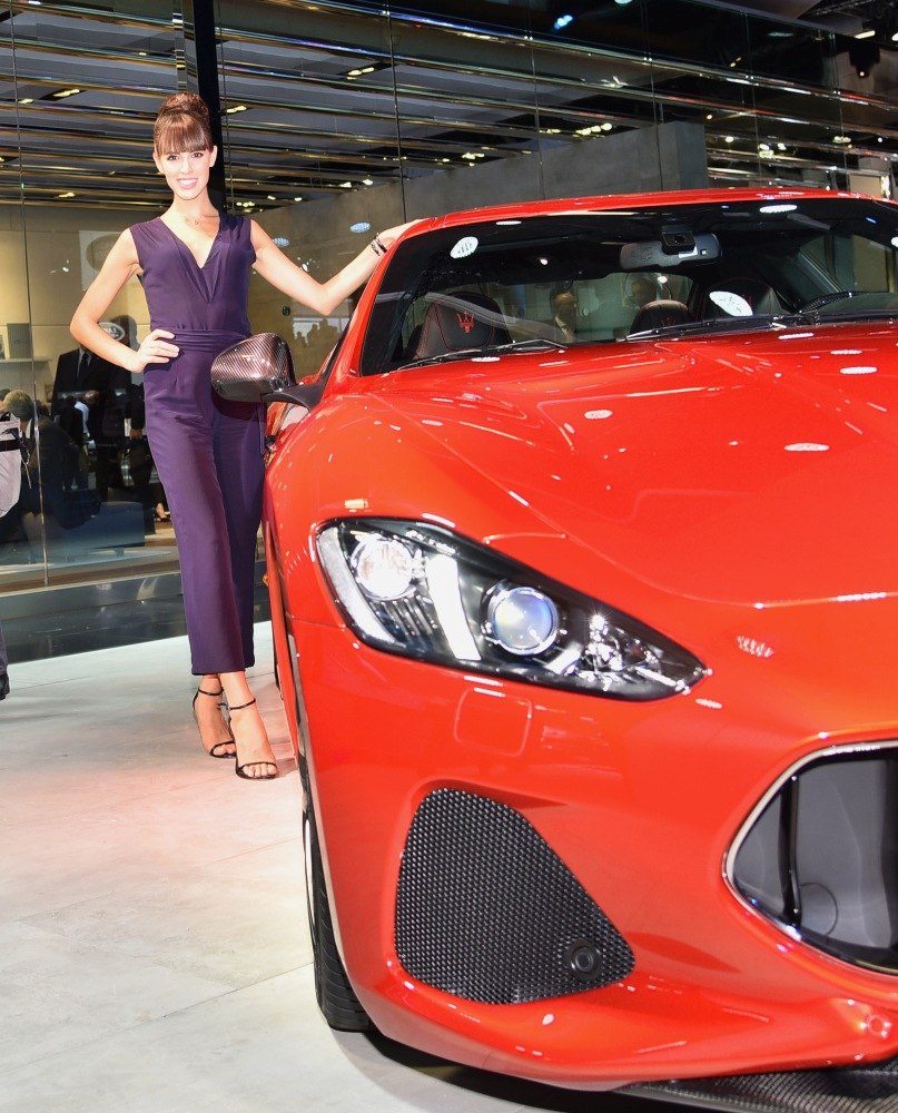Front headlight and grille of a red luxury sports car