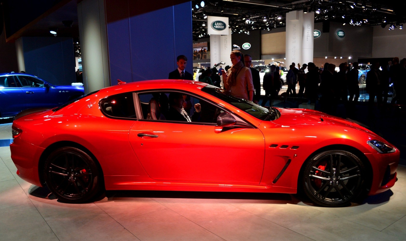 Red sports coupe with black matte wheels and sleek side profile