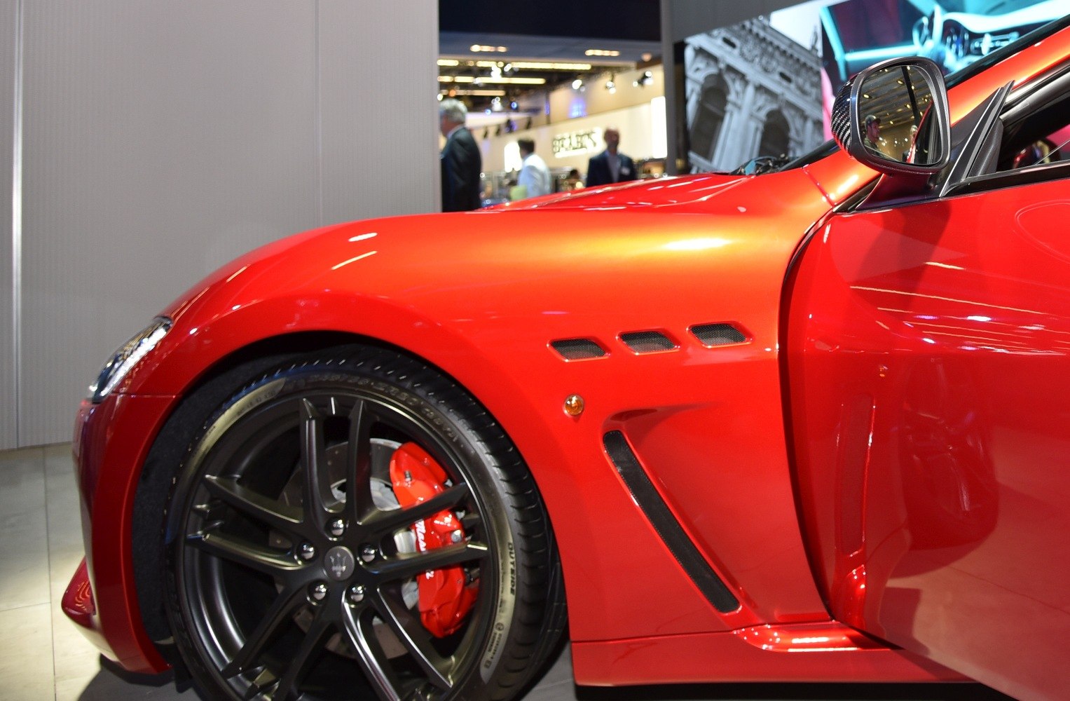 Front fender and wheel with black alloy and red brake caliper