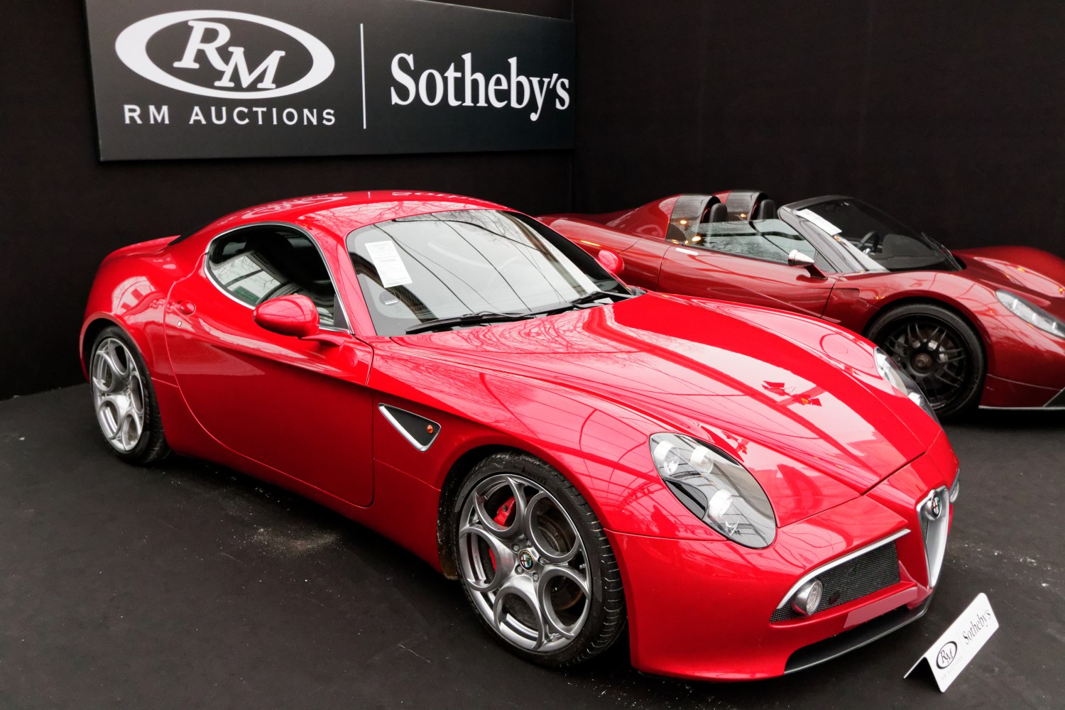 Red sports coupe with five-hole alloy wheels and aerodynamic body
