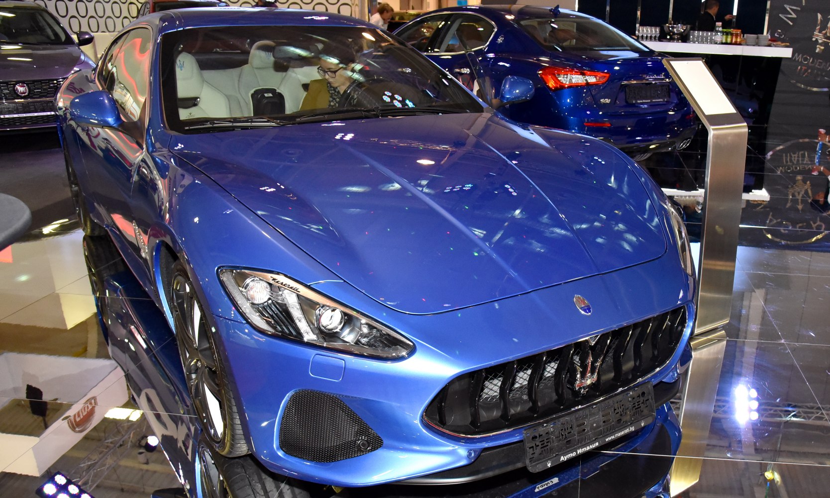 Blue sports car front view with grille and headlights