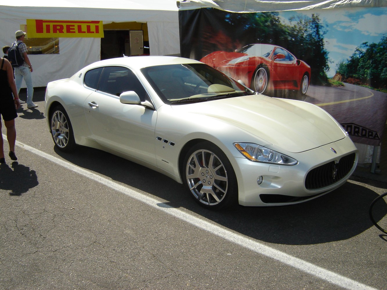 White luxury coupe front side with distinct grille and alloy wheels