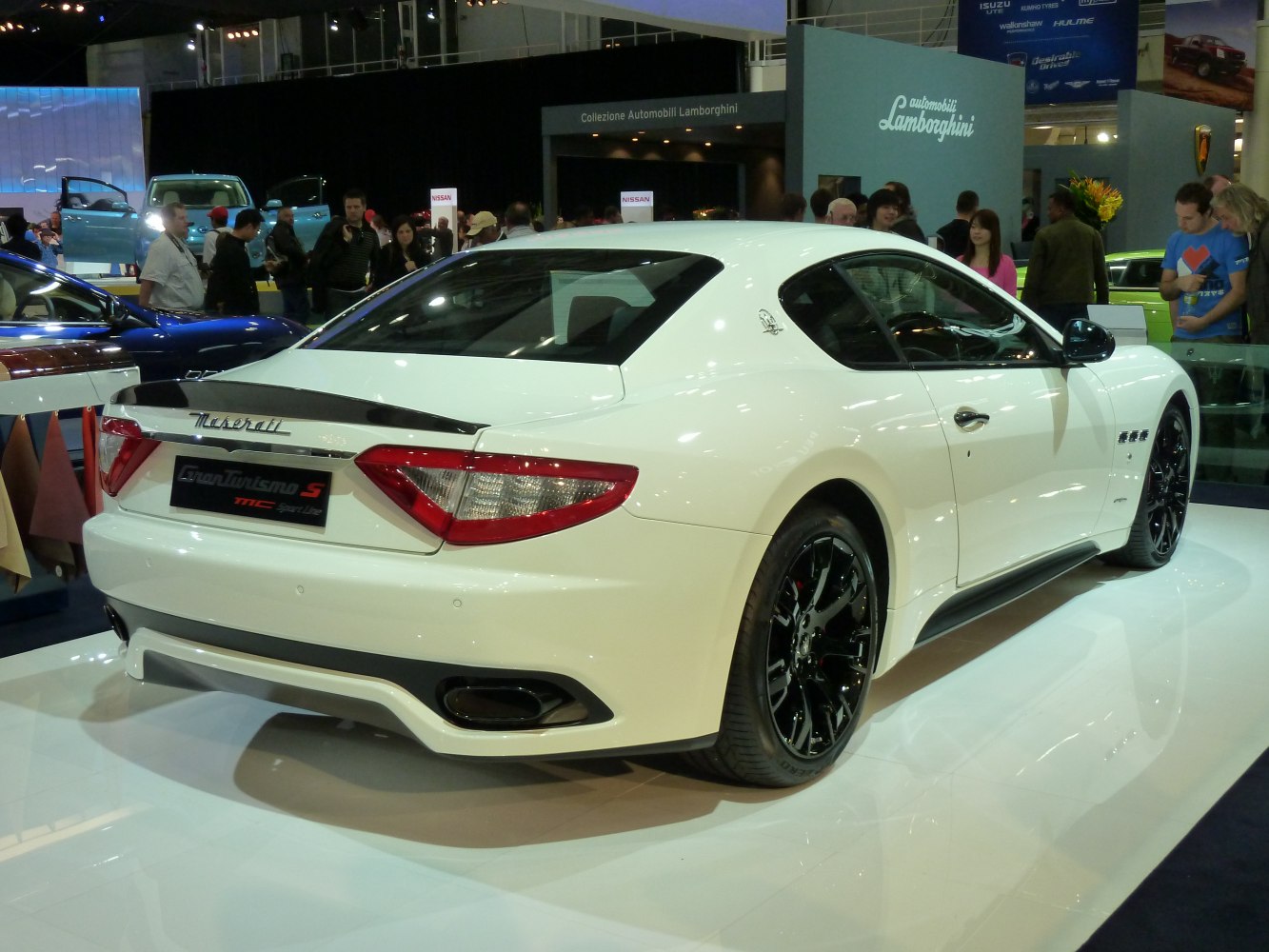 Rear-side sporty coupe with black rims and rear spoiler