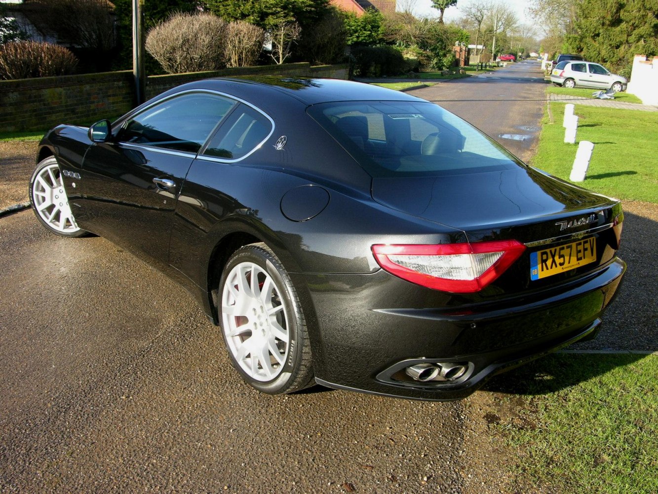 Sleek rear side view with quad exhaust and sporty alloy wheels.