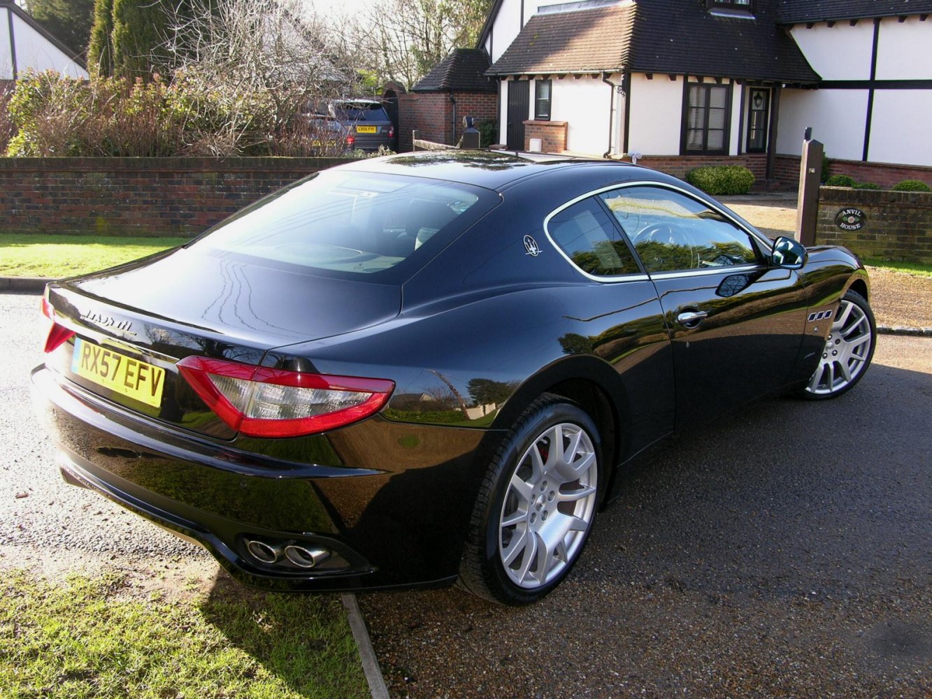 Rear and side view showing sleek curves and dual exhausts