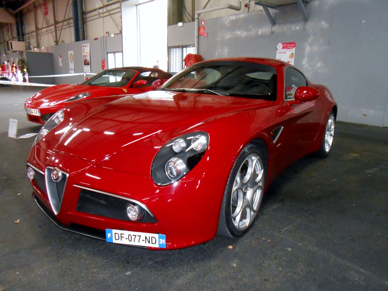 Front and side view with distinctive headlights and sporty red body