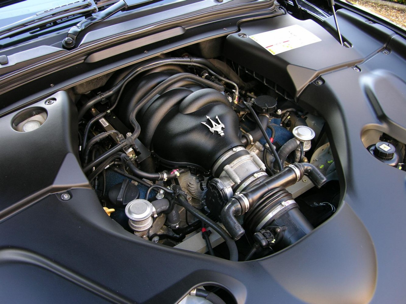 Close-up of V8 engine intake manifold and surrounding components.