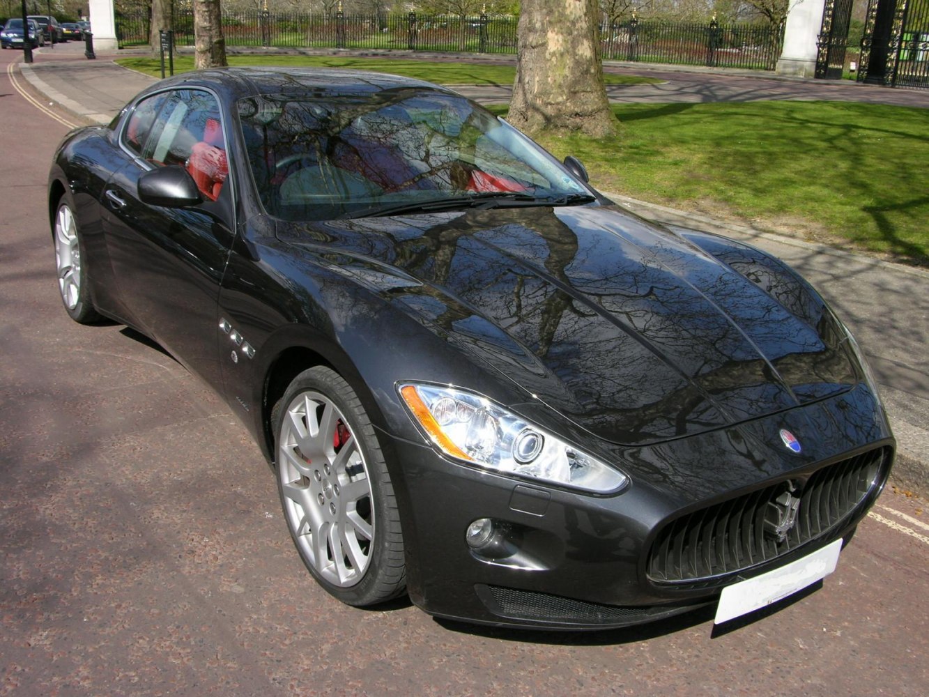 Front view of sleek sports coupe with prominent grille and alloy wheels
