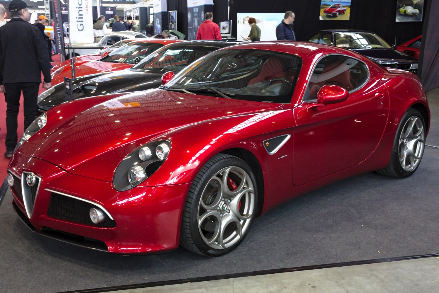 Red sports coupe with distinctive headlights and alloy wheels